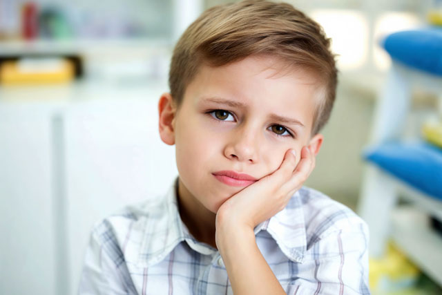 A child with a toothache at the dentist's office